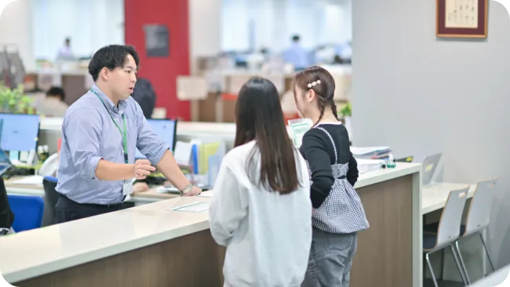 受付で話を聞く学生